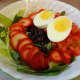 Boiled egg, strawberries, black beans, tomatoes, spinach, and iceberg lettuce