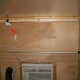 I used an extendable handle from a broken duster to measure the distance between the walls where the shelf goes. Twisting the handle locked it to the correct length.