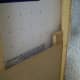 A piece of wood was added to give something to attach the paneling to at the corner. Some strips of wood could have been attached to the existing stud for attaching the paneling before it was installed.