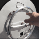 Close up, pointing at flat stainless steel pan with ring burner.