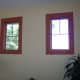 These windows are highlighted with a dark red border which eliminates the need for a traditional window treatment.