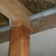 Detail of the roof support going through the garage soffit.  The post is notched on this one because of a garage rafter inside.