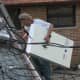 David carries foam sheeting to lay on top of the old asphalt shingles