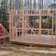 After framing each wall, nail on a diagonal board to keep the wall square.