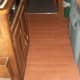 RV kitchenette floor with no trim on the sides, carpet trim on the ends of the area