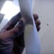 Bending the paper tape into a V to find which is to go to the wall.