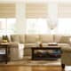 Nice, neutral living room. The leaves, apples and pillows add just the right amount of pop. The contrast of the sofa color and dark tables works, too.
