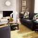 The gold of the area rug and vase here really make the couches pop, as well as the oversized pillows and wall colors.