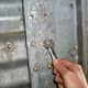 Keep a set of standard box-end wrenches handy on old bins, as not all bolts may be the same.