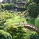 Japanese Zen—typified by peaceful, curving shapes of green rolling hills, round-canopied trees and bushes, and bridges over streams of slow-moving koi.
