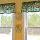 Bird print valences were made out of inexpensive fabric. Hand painted plaques carry out the bird theme.