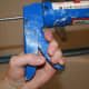 Squeeze the trigger once or twice to get the caulk tube to stay put.