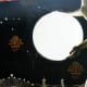 Stenciled fleur-de-lis to fill in the blank space around the moon. Also, the bubble has been reduced to a wrinkle in the paper.