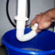 Drain the water from the trap nut slowly and keep an eye on the water level in your bucket.