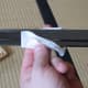 Wiping away the old oil on a katana with a sheet of nuguigami. Sharp edge of the blade facing away, wiping always from hilt to tip.