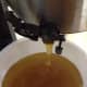 Honey Flowing out of the Extractor into a Bucket