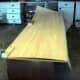 The veneer is clamped to the desktop to mark for cutting