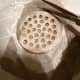 Cut out the circle 1/4 to 1/2 inch larger than drain.