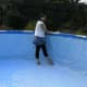 Erecting the pool, pushing out the creases before filling with water