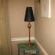 A tall, slim lamp helps to brighten up a dark corner.