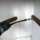 Using the flexi bit holder to screw batons to the wall for fixing the cupboard shelf.