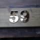 New brass house numbers test laid on decking offcut