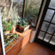 Porch renovations complete; showing built-in shoe rack with sliding doors.