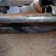 Cutting a length of hardwood timber to the correct width and depth to make beading.