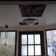 Cutting access holes in the ceiling to add 6 inches of insulation.