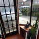 Porch renovations complete; showing cupboard with louvre doors and rack for umbrellas and walking sticks.