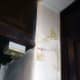 Brick wall between hall and porch with new bell wire concealed under the plaster.