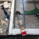 Removing old paint from the leaded glass windows.