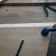 Place the plywood over one of the pieced of pine board, with the edge about an inch in.