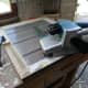 Using a belt sander to clean take the window frames back to the bare wood.