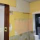 Light switch relocated to wood panel by backdoor.