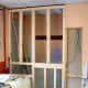 Building of the stud wall in front of space where the old back door was; space behind stud wall then utilised as a cloakroom, with access from the living room.
