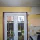 Plasterboard fixed to the wall on both sides of the door to level it with the lintel.