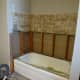 Only the lower piece of wallboard was removed at this point. It will be easy to get the tub out and the removal of the rest won't require standing in the tub while working.