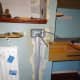 Metal back box for socket fitted in place and protective cover over cables in wall.
