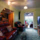Living room as it is now, with the old net curtain replaced by a roller blind on the other side of the wall; and out of sight when not used.