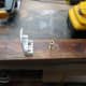 Fitting brackets to teak wood, and predrilling holes for fitting to the conservatory wall.
