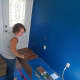 With the walls and ceiling freshly painted, we began to install the laminate flooring.