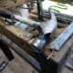 Using an old chisel with a claw hammer to remove all the upholstery nails.