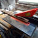 Cutting the wood to the correct width on a bench saw.
