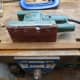 Using an electric sander to round the edges of the front stretcher to closely match the stretchers in the other chairs.