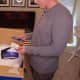 My husband unpacks the new Sweetnight mattress and goes through the documentation inside.