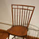 This Windsor chair has no arms and is made of solid, sculpted wood.