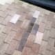 The gray areas are actually the top half of a good shingle. The bottom half of the shingle above it on the roof has been broken off and needs replacing.