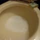 Spray or pour white vinegar into the inside of the toilet bowl and scrub while it is fizzing and reacting with the baking soda