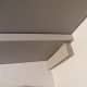 I screwed in the 1 by 2 inch board to support the longer shelf, then laid the shorter shelf on top. Easy!